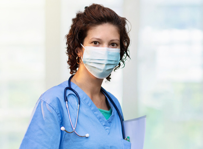 Doctor or nurse with stethoscope and face mask.